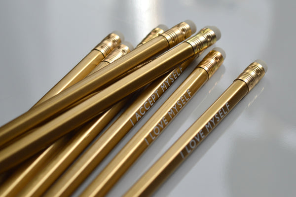 Gold foiled affirmation pencils reading: I love myself, I accept myself, I forgive myself