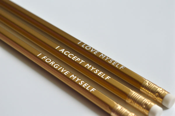 Gold foiled affirmation pencils reading: I love myself, I accept myself, I forgive myself