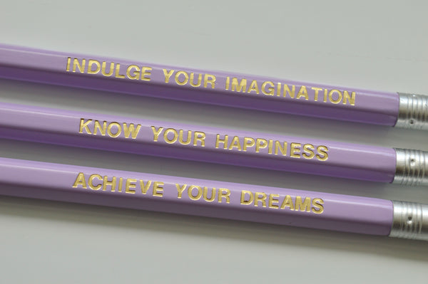 Gold Foiled lilac imagination pencils reading: indulge your imagination, know your happiness, achieve your dreams