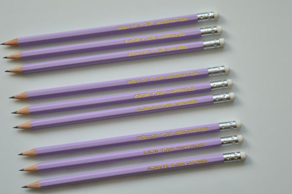 Gold Foiled lilac imagination pencils reading: indulge your imagination, know your happiness, achieve your dreams