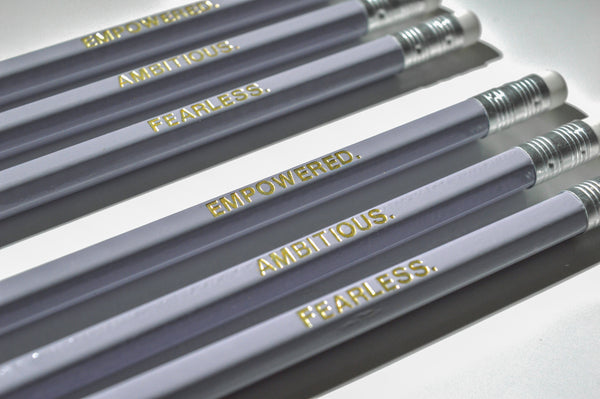 Gold Foiled empowered pencils reading: Empowered, Fearless, Ambitious