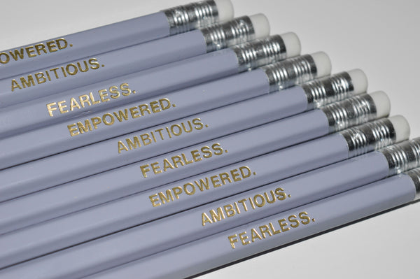Gold Foiled empowered pencils reading: Empowered, Fearless, Ambitious